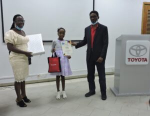 Mr. B Onafowokan, presenting certificate to Aishat Ayomide Ogunbanwo, winner 2nd Position 8-11 years category, with her mum sharing in her joy